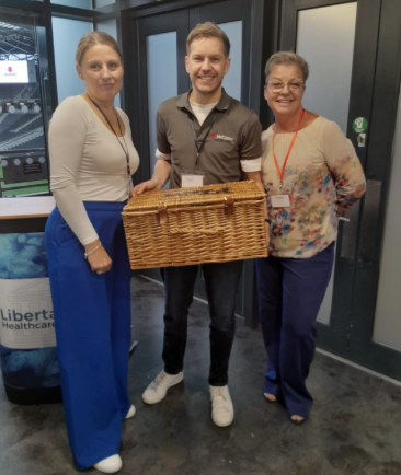 Attendees at conference holding basket 